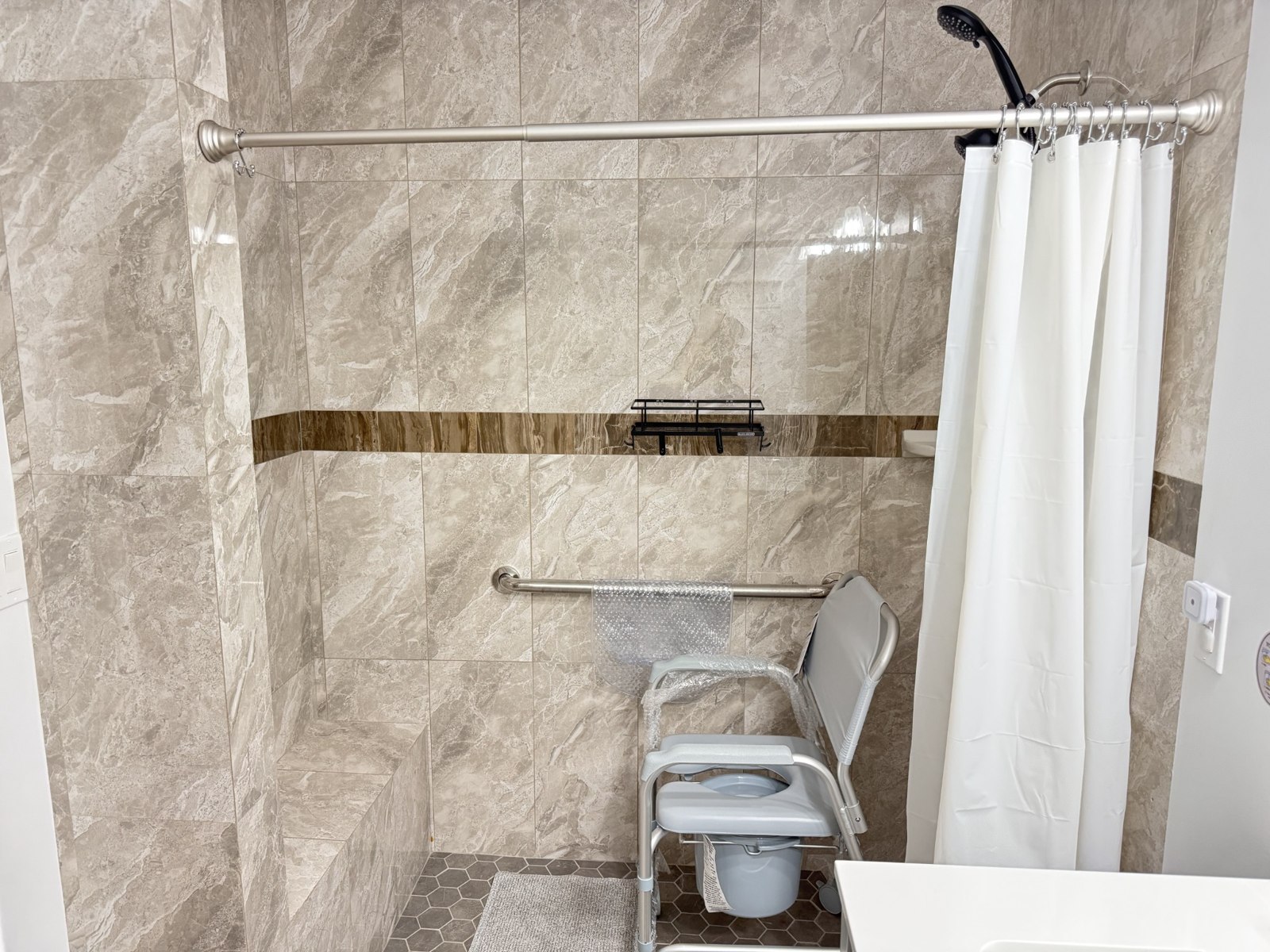 Shower chair, handheld shower, and grab bars