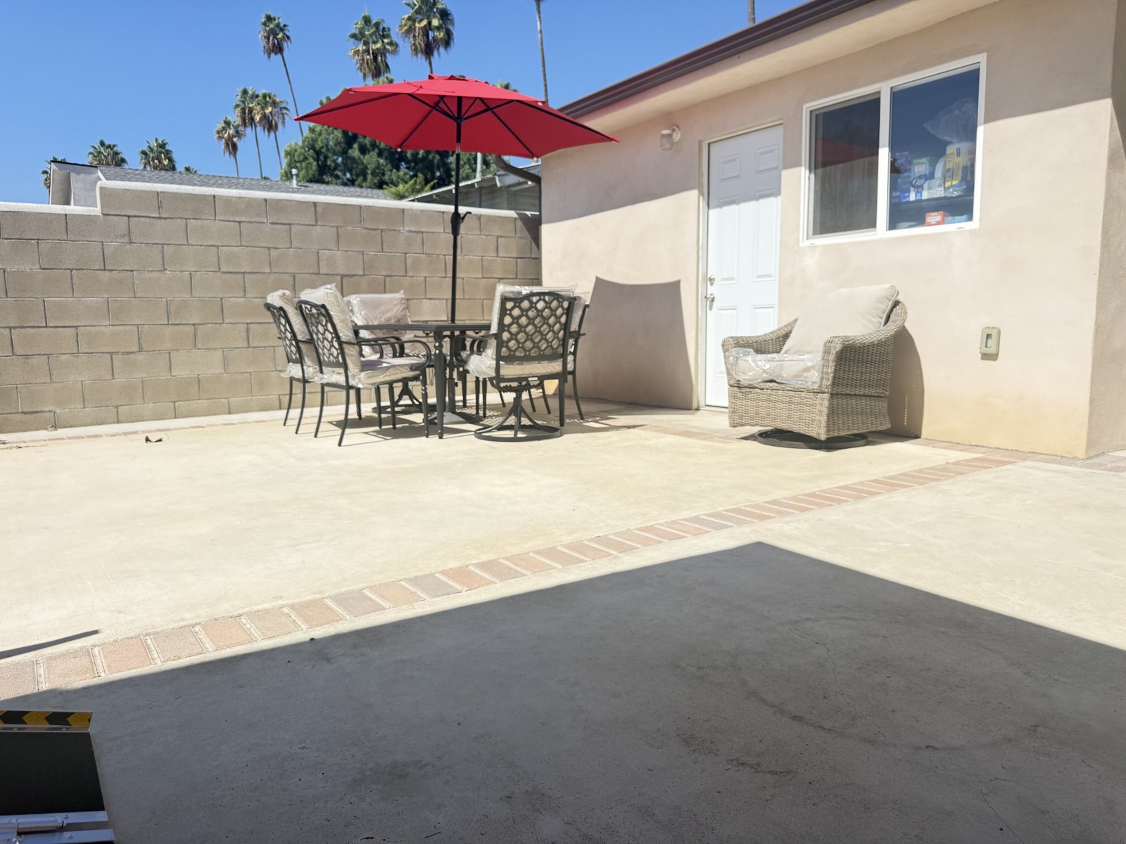 Outdoor patio with table, chairs, and umbrella